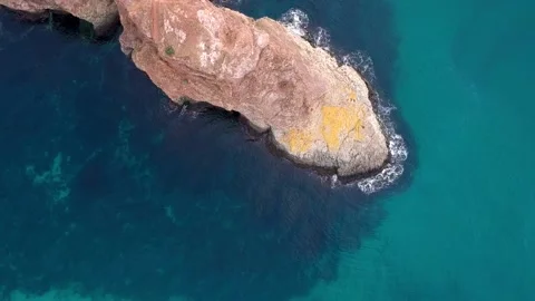 The view from the bird's eye view on the steep coast with crystal clear turqu Stock Footage 131801705