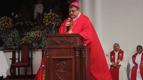 View of a bishop reading the Bible during an open-air mass in Latin America Stock Footage 86520480