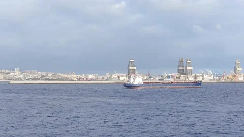 View of a blue cargo ship and a cargo port in the background Stock Footage 210213040