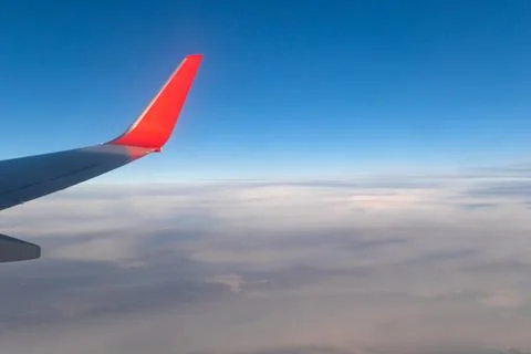 View of the blue clear sky from the height of flight above the clouds from th Stock Photos