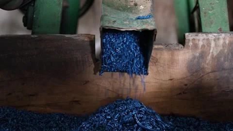 View of blue plastic pellets falling from a chute, Bangladesh. Stock Footage 336412168
