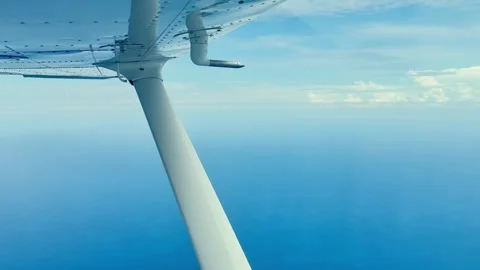 View of the blue sea from the window of a small plane Stock Footage 309474235