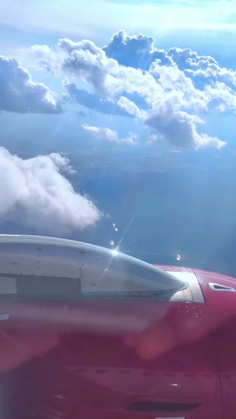 View of the blue sky above the clouds from the airplane window. Air travel. Stock Footage 283016402