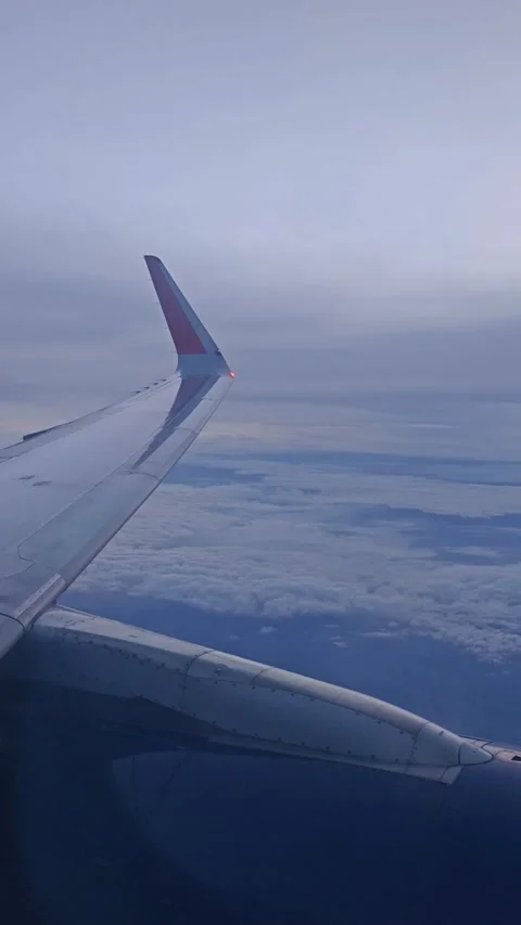View of the blue sky above the clouds from the airplane window in the evening. Stock Footage 283071967
