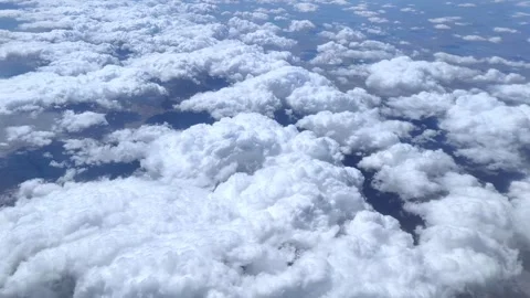 View of the blue sky above the clouds from the airplane window. Air travel. Stock-Footage 283247904