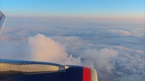 View of the blue sky above the clouds from the airplane window. Air travel. Stock Footage 285263303