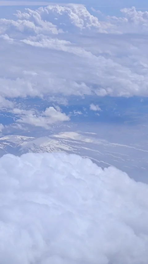 View of the blue sky above the clouds from the airplane window. Air travel. Stock Footage 309551202