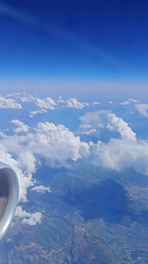 View of the blue sky above the clouds from the airplane window. Air travel. Video stock 310297771