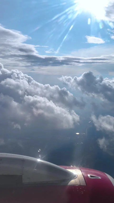 View of the blue sky above the clouds from the airplane window. Air travel. Video stock 333686062