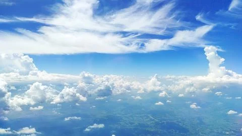 View of a blue sky with different types of clouds - white fluffy cumulus and Stock-Fotos