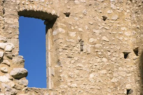 View of blue sky outside a window of 12th century French castle ruins Stock Photos