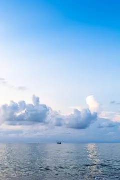 View of blue sky in over calm sea water at dusk Stock Photos
