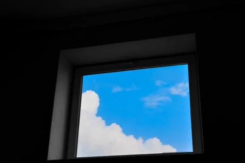 View of Blue Sky Through Dark Indoor Window Frame Stock Photos