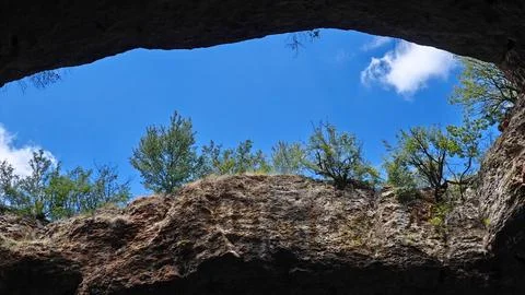 View of Blue Sky Through a Large Natural Cave Opening Photos