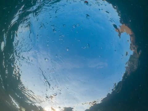 View of the blue sky through the thickness of the turquoise sea water Stock Photos