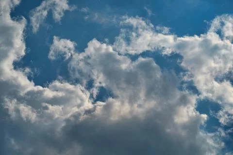 View up into a blue sky with white clouds at a sunny day. Stock Photos