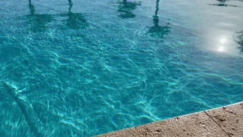View of blue swimming pool from the bottom to the sky with the palm trees Stock Footage 170793633