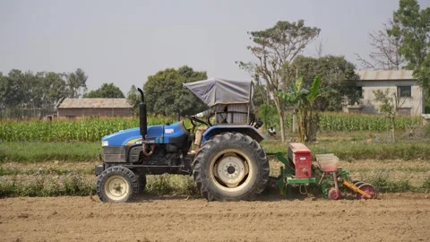 View of a blue tractor working in a rural field, Nepal. Video stock 335473602