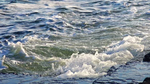 View of the blue waves with foam on the sea Stock Footage 229895796