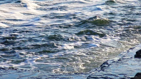 View of the blue waves with foam on the sea Stock Footage 229895839