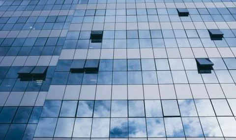 View of blue windows in a skyscraper modern offices building -  concept of pe Stock Photos