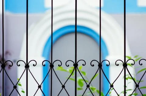 View of the blurred blue arch through the bars Stock Photos