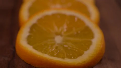 View Of Blurred Orange Slices Panning up 4K 스톡 동영상 131097129