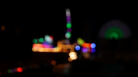 View of blurry lights of carnival faiground at night Stock Footage 120138516