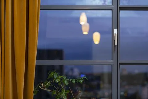 View of the blurry skyline during sunset night, with an ochre yellow curtain Stock-Fotos