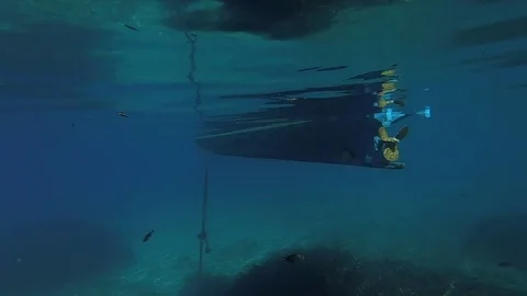 View of the boat and many ropes from the depths of the sea water Stock Footage 80584538