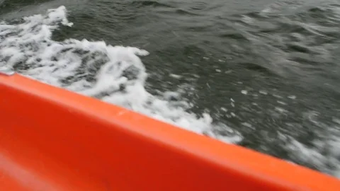 View from boat bow when fast moving over water with regatta in background Stock Footage 75077431