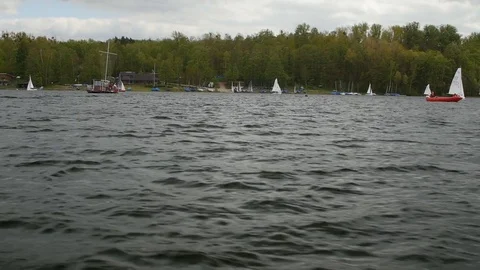 View from boat bow when fast moving over water with regatta in background Stock Footage 75078482