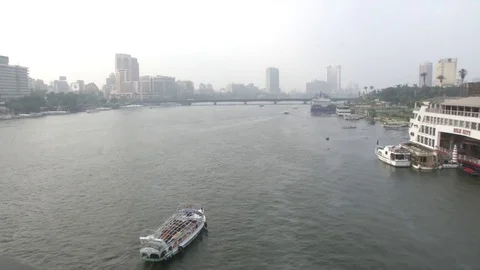 View of Boat going down Nile River and Overview of Cairo Buildings Stockbeeldmateriaal 82320213