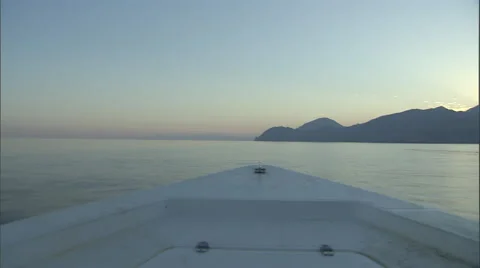 View from a boat as it sails on a lake surrounded by mountains. Stock Footage 46868466