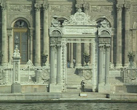 View from boat passing gate of Dolmabahce Palace Stock Footage