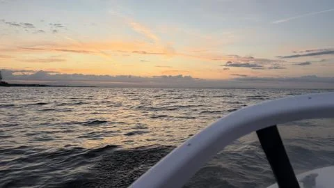 View from a boat with a white railing in the foreground, looking out over Stock Photos