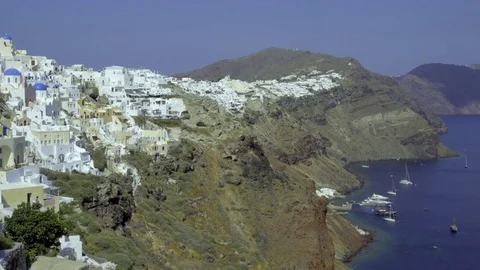View of boats moored on the coast below Santorini Stock Footage 84175267