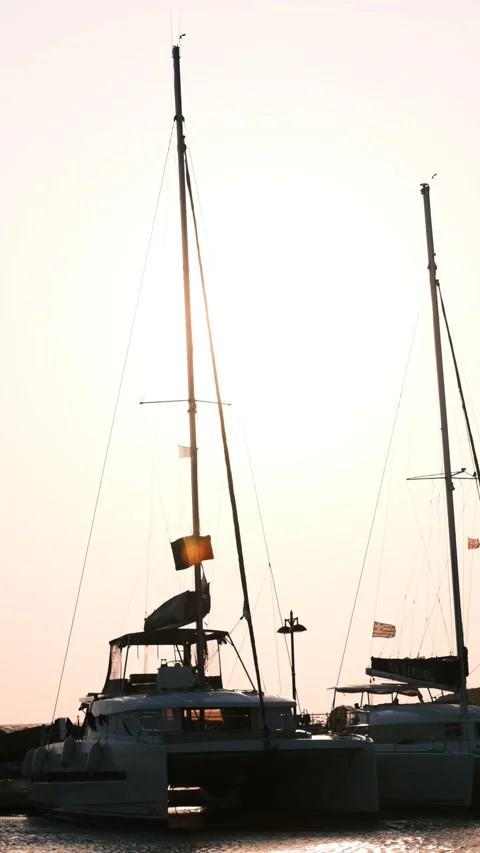 View of boats in a port at sunset with flags waving. Greek island. Stock Footage 151055909