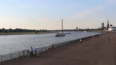 View of boats on Rhine river and people walking next to it in Dusseldorf. Stock Footage 80309723