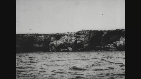 View of boats in sea and rock formation from u-boat Stock Footage