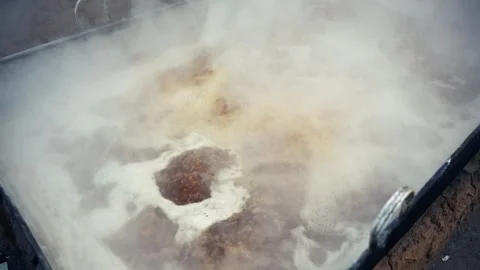 View of boiling jaggery liquid in a large metal vat, Bangladesh. Stock Footage 335765934