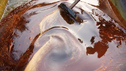 View of boiling molasses being stirred in a large vat, Bangladesh. Stock Footage 335765841