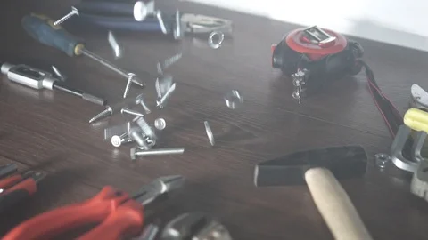 View bolts nuts self-tapping screws fall on the table, hand tools in the Video stock 101028748
