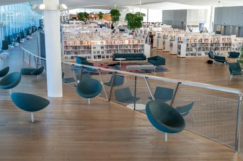 View of book hall inside Oodi Library on sunny day with shelves tables chai.. Stock Photos