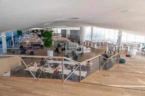 View of book hall inside Oodi Library on sunny day with shelves tables chai.. Stock Photos