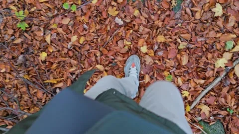 View of boots and legs wading through a sea of fall leaves, rocky terrain, .. Video stock 256288445