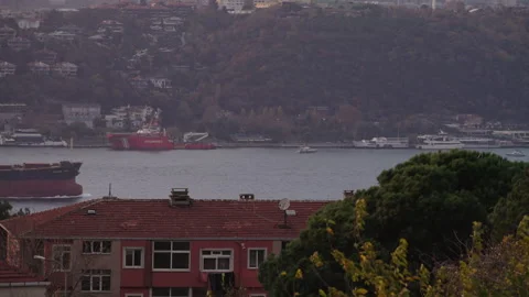 A view of the Bosphorus with a cargo ship and ferry sailing Stock Footage 303760899