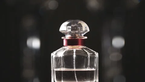 View on bottle of luxury perfume with light reflection on it. Blurred background Stock Footage 138444359