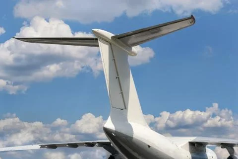 View from bottom on airplane tail with horizontal stabilizer against of a clo Stock Photos