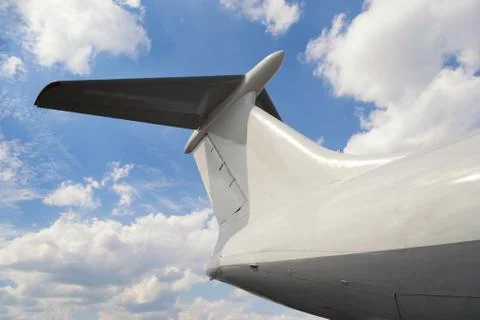 View from bottom on airplane tail with horizontal stabilizer against of cloud Stock Photos